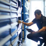 Service technician choosing parts from drawers