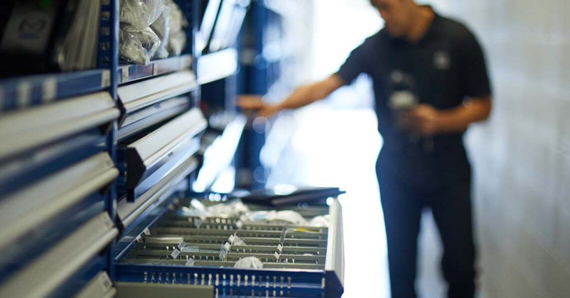 Service technician choosing parts from drawers